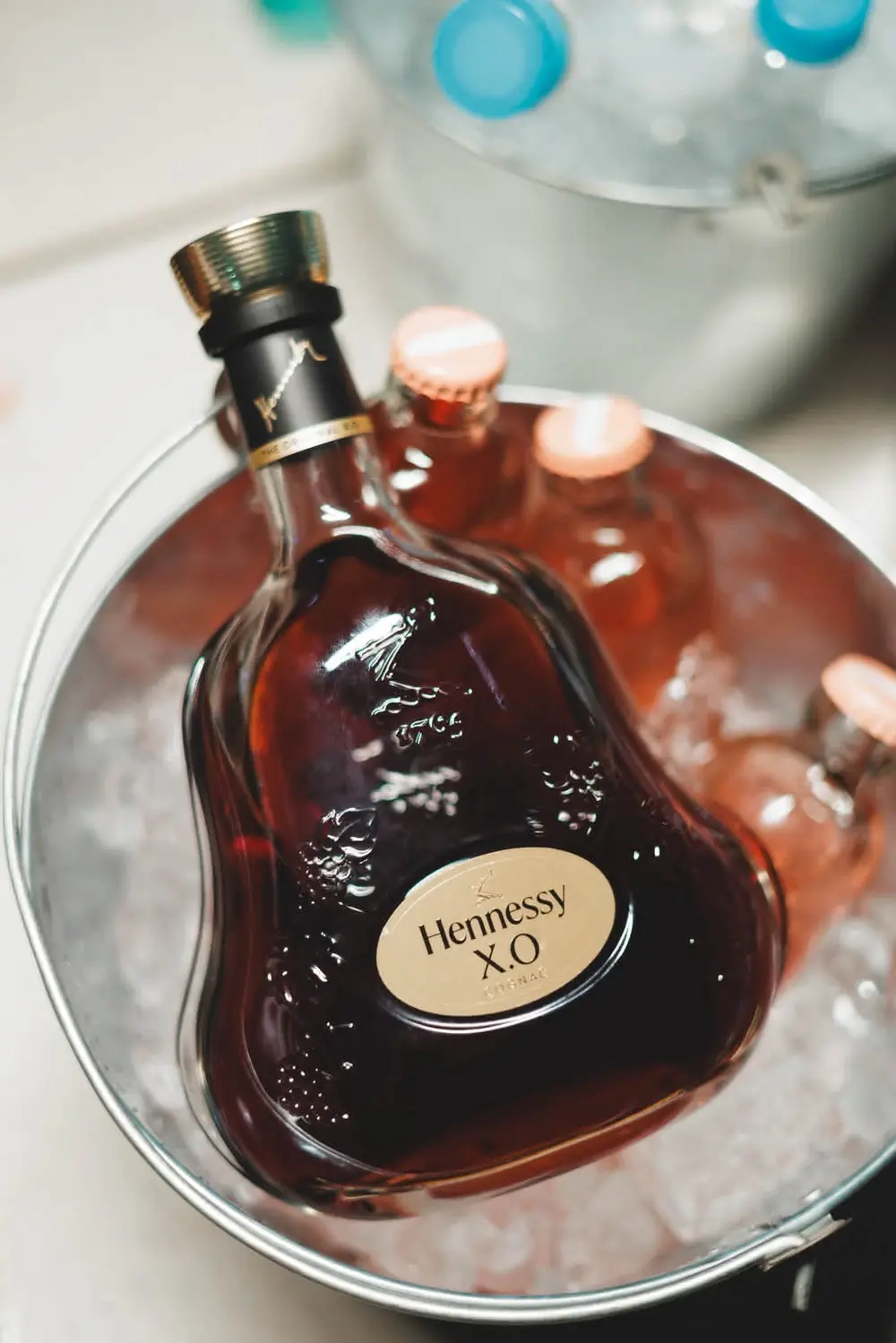 Bottle of Hennessy X.O on ice in a bucket