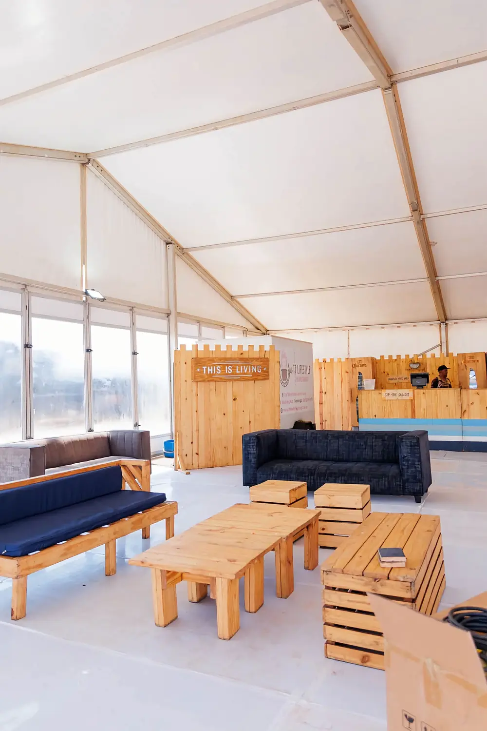 Marquee lounge with wooden furniture and a pop-up bar